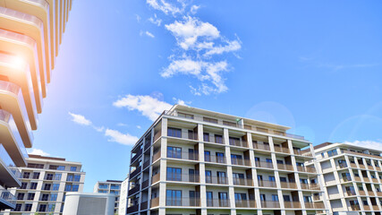 Modern apartment buildings on a sunny day with a blue sky. Facade of a modern apartment building....