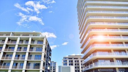 Exterior of a high modern multi-story apartment building - facade, windows and balconies.