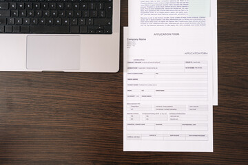 Organizing important paperwork and applications on a desk at home office