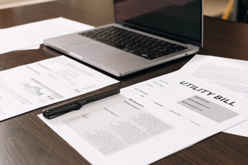 Documents on a desk with a laptop during a home or office organization session