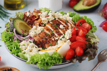 A bowl with cobb salad, traditional American dish