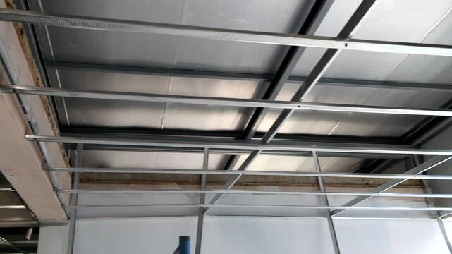 House renovation project focusing on intricate interior ceiling framework and electrical wiring installation, detailed look at new home structure build out.