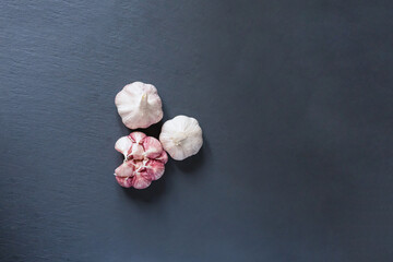 scattering of whole head of garlic in a dark  background