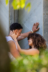 young latin couple on the street with an affectionate gesture