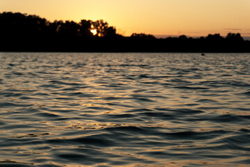 Ggentle waves rippling across a calm river surface.  Water texture is ideal for use as a natural background, meditative or peaceful ambient element. 