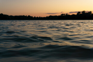 Ggentle waves rippling across a calm river surface.  Water texture is ideal for use as a natural background, meditative or peaceful ambient element. 