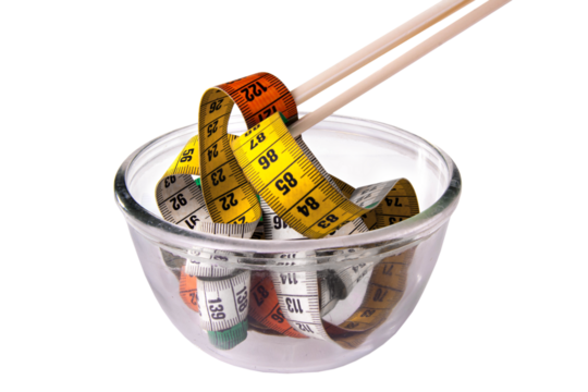 measuring tape with chop stick on a transparent bowl isolated on white, diet concept