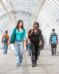 Obraz premium Teenage Students, Walking to School. A pair of female college friends walking together on their way to class. From a series of related images.