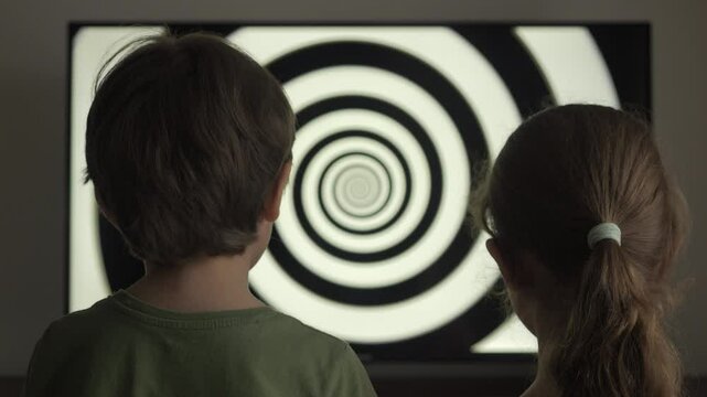 Children Watching Hypnotic Spiral on TV Screen. Influence of Media on People. Broadcast False Information, Hoax, Propaganda Brainwashing Disinformation. Manipulation Crowd Fakes, False Information.