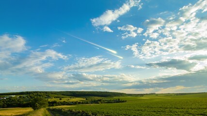 Shooting stars in the sky at sunset. Meteor trails above the clouds, dreamy landscape. Fireballs...