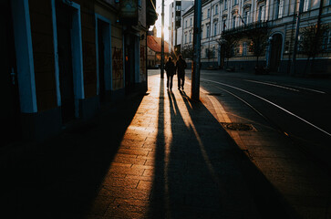 Evening silhouette of a city walker on the street, capturing urban lifestyle under golden light