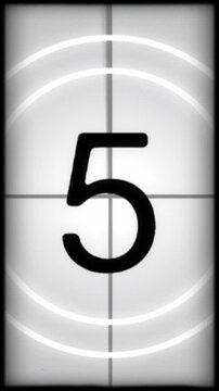 Vintage Film Head Countdown Vertical Background. Old, projected film head leader with realtime countdown clock. Worn and damaged in style including marks, scratches and film grain.