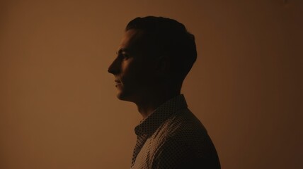 Silhouette profile of a caucasian young male in dramatic lighting