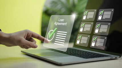 A person is pointing at a laptop screen that displays a loan agreement. Concept of financial responsibility and the importance of understanding the terms of a loan agreement