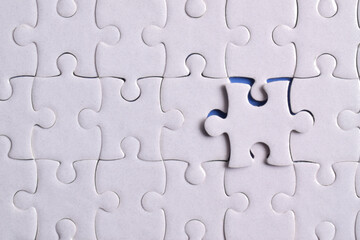 Missing jigsaw puzzle pieces and business concept on blue background. Completing final task