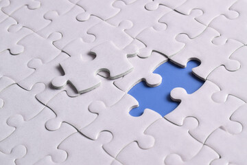 Missing jigsaw puzzle pieces and business concept on blue background. Completing final task