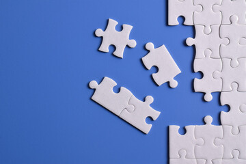 White puzzle with missing piece on blue background. Flat lay. Top view