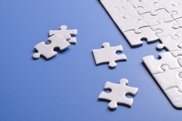 White puzzle with missing piece on blue background. Flat lay. Top view