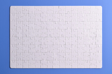 White puzzle pieces on blue background. Flat lay. Top view