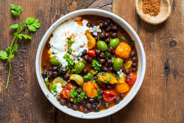 Black chickpeas stew with nocellara olives, tomatoes and orange