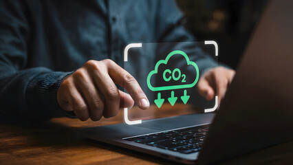 Green technology concept showing reduction of carbon dioxide on a laptop, signaling a commitment to sustainable energy and environmental responsibility within the digital realm.