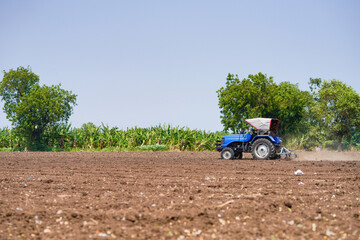 tractor working in the agricultural empty field