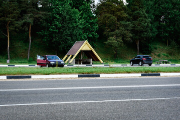Car parking near forest and lake. Road trip concept, car driving travel in summer season.