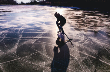 A person is skating on a frozen lake