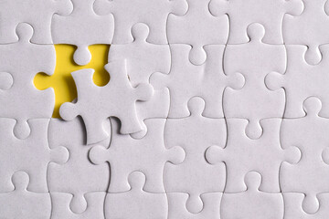 Missing jigsaw puzzle pieces and business concept on yellow background. Completing final task