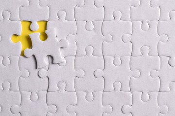 Missing jigsaw puzzle pieces and business concept on yellow background. Completing final task