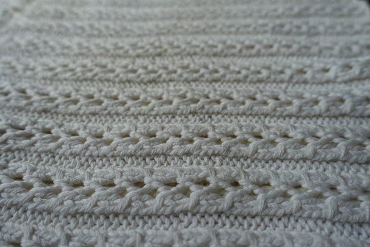 Close view of white striped handmade knitted lace fabric