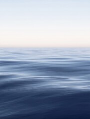 Tranquil and ethereal seascape with smooth, rippling water merging into a pale sky, creating a minimalist and calming horizon view perfect for meditation and relaxation