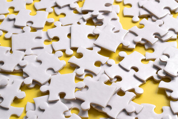 Pile of white puzzle pieces as background, top view