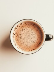 A close up view of a cappuccino in a white cup, showcasing the intricate bubble patterns on the surface of the coffee, set against a neutral background