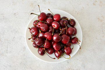 Freshly Picked Cherries on a White Plate top view
