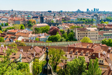 A view from the castle complex across rooftops on the west bank of the Vltava river in Prague in springtime