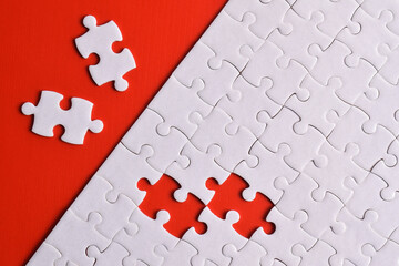 White puzzle with missing piece on red background. Flat lay. Top view