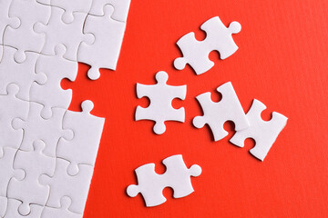 White puzzle with missing piece on red background. Flat lay. Top view