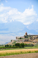 Church and beautiful natural landscape. Monastery in nature. Armenian monastery Khor Virap. Beautiful architecture of the church. Monastery against the backdrop of rocky mountains. Christianity