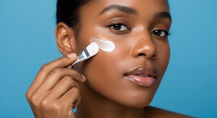 Radiant Beauty: An African American Woman Applies Skincare Product with Brush, Close-up on Flawless Skin and Cosmetic Ritual, Dark-Skinned Model Uses Brush to Apply a Cream on her Cheek