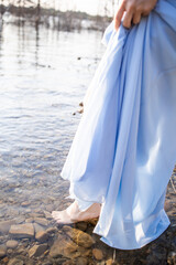 Water nymph. Woman in a blue dress. Mavka. Step into the water. Water nymph. Mavka