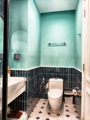 Discover a contemporary bathroom interior design that boasts vibrant turquoise walls contrasted by...