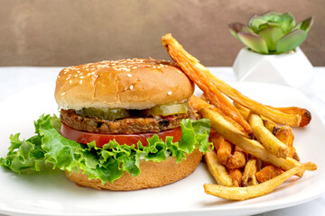 gadenveggie burger top with pickles on a sesame bun