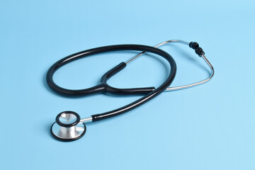 Medical stethoscope on light blue background. Health care concept