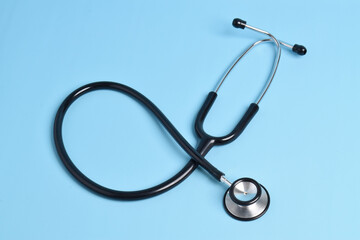 Stethoscope on light blue background. Health care concept