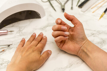 Nail manicure at home, female hands showing her nails.