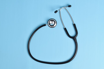 Stethoscope isolated on light blue background, top view. Medical instrument