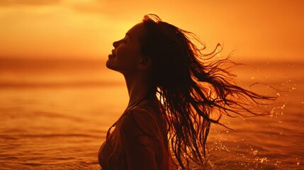 Fototapeta premium Joyful female with wet hair gently swaying in sea, orange sky mirroring off smooth water.