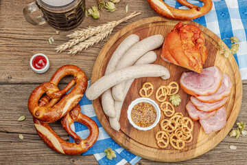 Traditional Oktoberfest set. Pretzels, beer, weisswurst, eisbein with mustard. German festival food