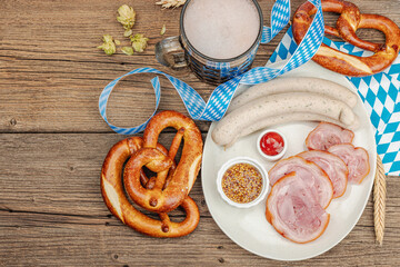 Traditional Oktoberfest set. Pretzels, beer, weisswurst, eisbein with mustard. German festival food